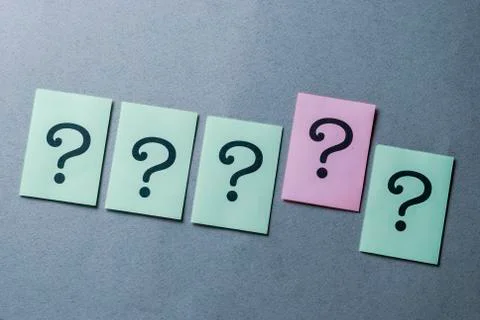 Line of four green question marks and one pink Stock Photos