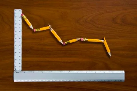 A line graph showing decline made from pencils and rulers 스톡 사진