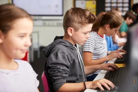 Line Of High School Students Working at Screens In Computer Class 스톡 사진