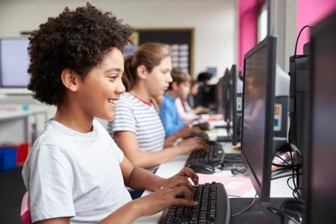 Line Of High School Students Working at Screens In Computer Class Stock Photos