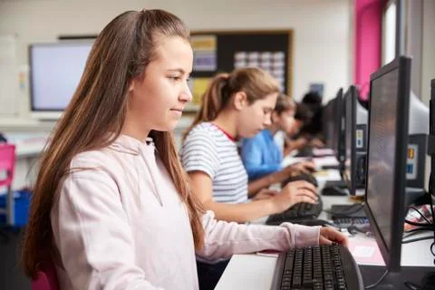 Line Of High School Students Working at Screens In Computer Class Stock Photos