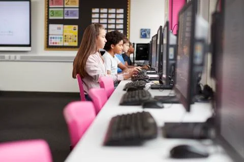 Line Of High School Students Working at Screens In Computer Class Stock Photos