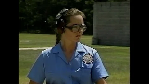A line instructor corrects students shooting long arms weapons and an AR-15 Stock-Footage 92629895