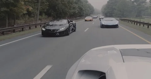 Line of Lamborghinis on highway 2 스톡 동영상 105122365