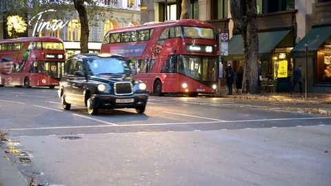 A line of London Black Cabs pulling away from a pedestrian crossing on a busy Video stock 125312216