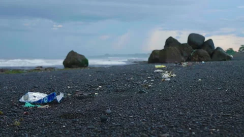Line of Ocean Plastic on Black Sand Beach, Bali Stock Footage 147285236