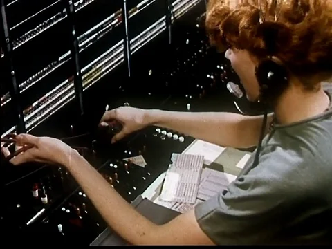 Line operator notes records before connecting call - 1950 Stock Footage 107363190