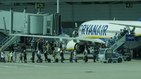 Line of passengers queuing to board summer holiday flight Stock Footage 201157032