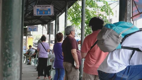 A line of people outside a make shift vaccination center Stock Footage 154747725