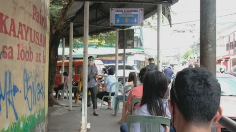 A line of people outside a make shift vaccination center Stock Footage 154747761