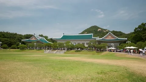 Line of people waiting to enter Main Office Hall (Bon-gwan) at Cheong Wa Stock Footage 197325694