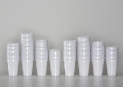 A line of piled up plastic cups. Stock Photos