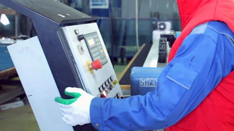 Line production of plastic windows. Worker clicks on the buttons for the desired Stock-Footage 93126069