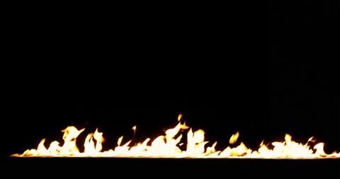 A line of real flames starts to burn on a black background. Isolated fire Stock Footage 142070312