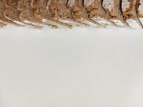 Line of slices of black rye bread on a white background Foto stock