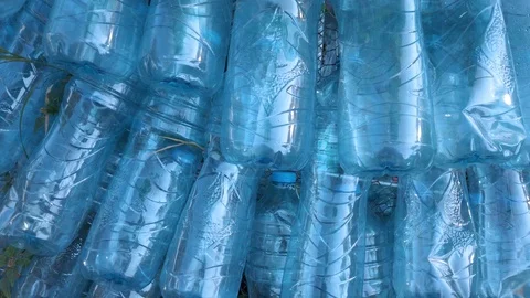 Line stacked Blue empty plastic bottles - pan shoot Video stock 121391350