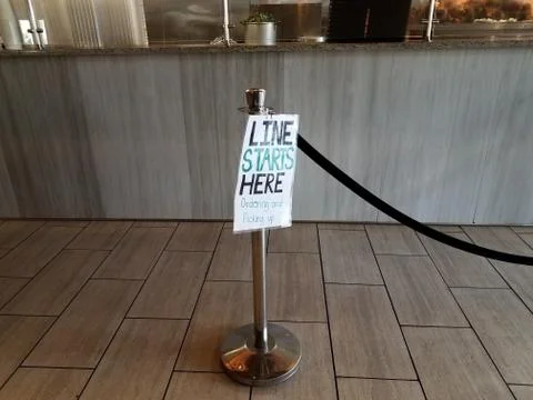 Line starts here ordering and pickup sign in restaurant Stock Photos