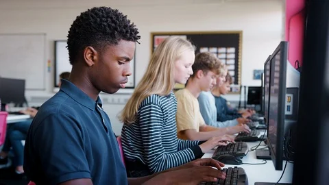 Line Of Teenage High School Students Studying In Computer Class Stock Footage