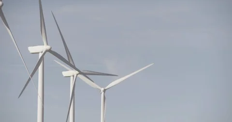 Line of Three Wind Mills in Motion Stock Footage 89942407