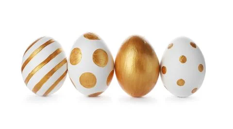 Line of traditional Easter eggs decorated with golden paint on white backgrou Stock Photos