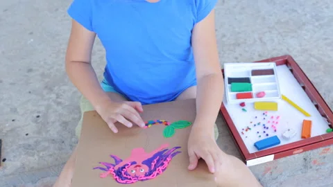 On-line training in creativity, the child sculpts on the street. The child Stock Footage 168805747