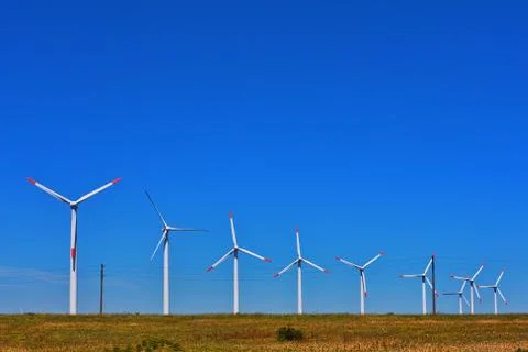 Line of windmills on the field Stock Photos