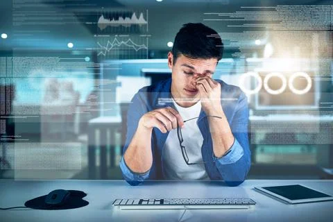 This line of work can be tiring. a focused young programmer working on his Stock Photos
