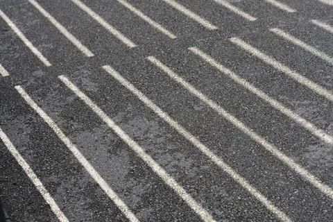 Linear shadows on an asphalt surface texture background Stock Photos
