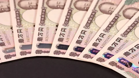 Lined up 10,000 yen bills close up, rotating Stock Footage 310864965