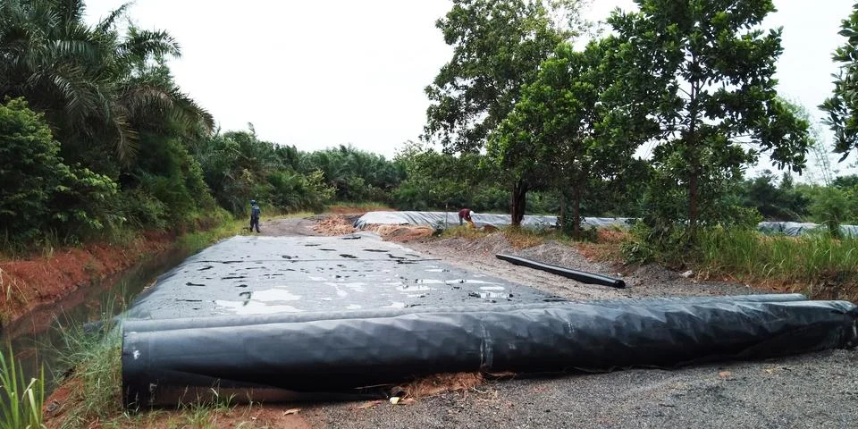 Lined Artificial Pond Under Construction with Workers Stock Photos