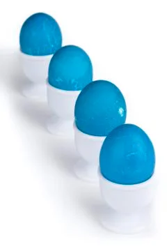 In lined blue eggs on a white cup Stock Photos