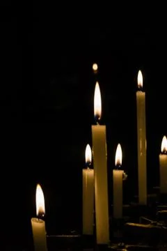 Lined up candles in closeup Stock Photos