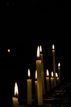 Lined up candles in closeup Stock Photos