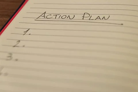 Lined notebook page with the words `Action plan` Stock Photos