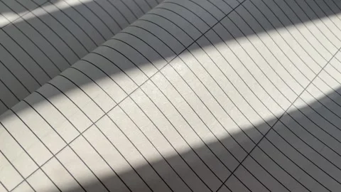 Lined Notebook Pages Flipping with Sunlight and Shadow Overlays Stock Footage 340214553