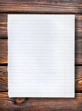 Lined paper on dark table Stock Photos
