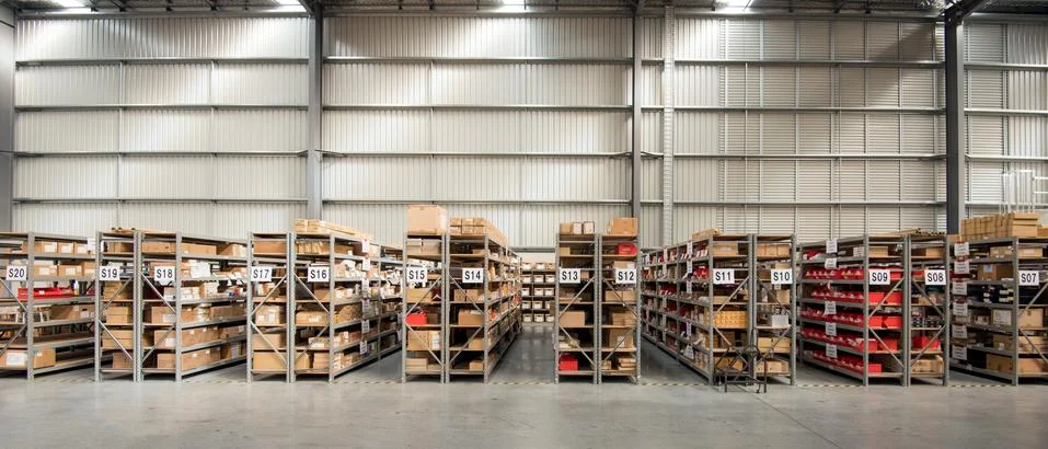 Lined up shelfs at Logistics warehouse Stock Photos