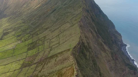 Lined slopes of green inactive stratovolcano. Aerial of Caldeirao volcano, Corvo Stock Footage 117306936