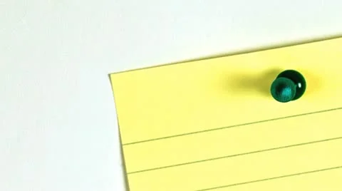 Lined sticky thumb-tacked to white background Stock Footage 21303130