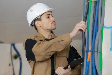 Lineman inspecting the lines of cables Stock Photos
