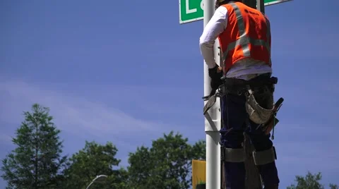 Lineman with safety climbing belt, Electrical Power Co. Stock Footage 50660430