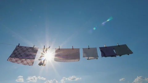 The linen dries on a rope, among it is a plush rabbit. Stock Footage 93281368