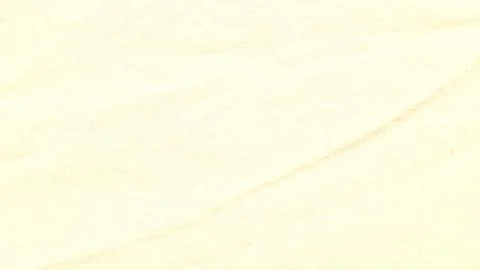 Linen fabric texture creates soft diagonal crease in warm ivory studio lighti 스톡 사진
