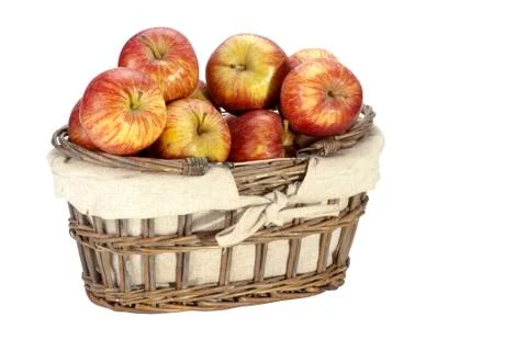 Linen lined wicker basket filled with red apples Foto stock