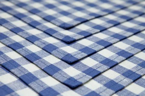 Linen napkins in blue cage lined background. Foto stock