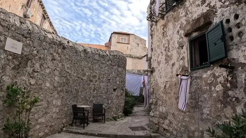 Linen sheets hanging out in the old city of Dubrovnik Stock Footage 255791094