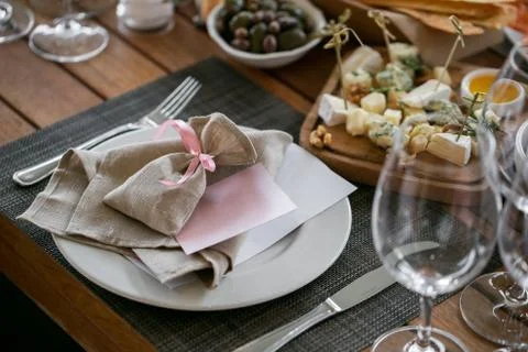 Linen textile. Decorated table, a plate of neatly arranged napkin, fork and Stock Photos