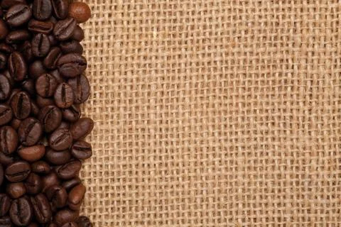 Linen texture with coffee beans Stock Photos
