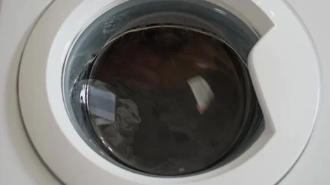 Linen is washed in a washing machine, view through the glass Stock Footage 240639930