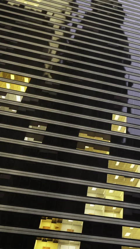 Lines and lights form pattern on tall building at night in urban setting Stock Footage 342452818